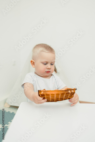 Obraz na płótnie In a joyful environment, a toddler plays with colorful toys at home, inspiring creativity and happiness while promoting development through exploration during crucial early growth w salonie
