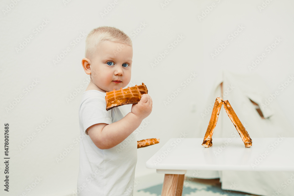 A curious little toddler joyfully exploring playtime with an array of colorful building blocks in a bright, cheerful, and minimalist room designed for creativity and learning during childhood