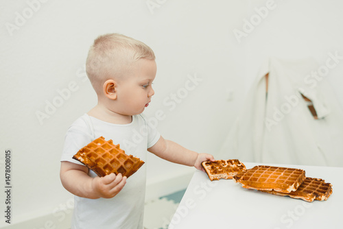 A Curious Toddler Engaged in Exploring Delicious Waffles at the Breakfast Table, Enjoying Their Morning Meal with Wonder and Delight, Filled with Innocent Joy and Childhood Curiosity