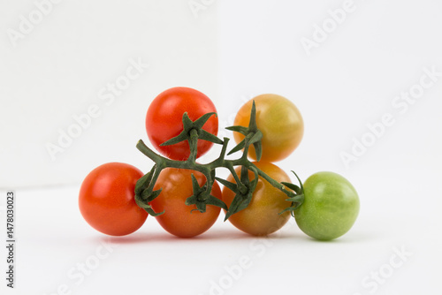 Yellow, Red, and Green Tomatoes on White Background