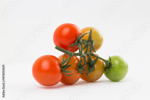Yellow, Red, and Green Tomatoes on White Background