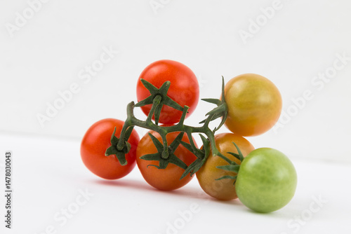 Yellow, Red, and Green Tomatoes on White Background