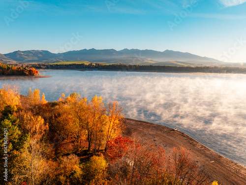 Obraz na płótnie Liptov region with Tatras mountains around. Liptovska mara dam landspace. Autumn deciduous forest view from above w salonie