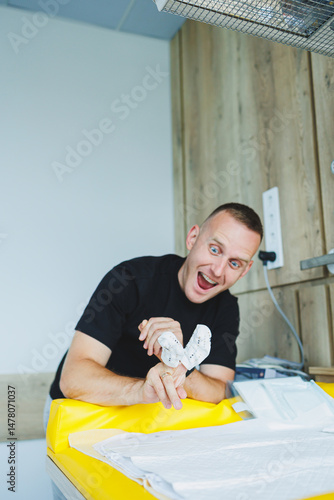 An enthusiastic man is fully engaged with his creative project while working in a modern and vibrant workspace filled with inspiration and innovative ideas that foster collaboration and success