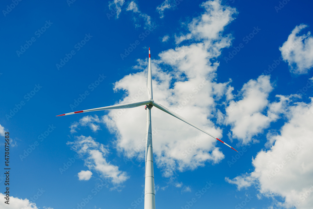 Large windmill turbine for energy generation. Ecological energy generation by windmills on the sky background.