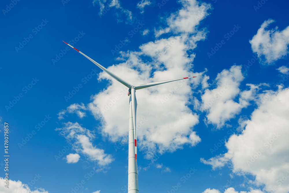 Large windmill turbine for energy generation. Ecological energy generation by windmills on the sky background.