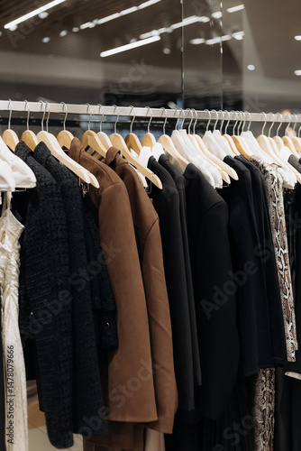 An Elegant Fashion Hanging Display showcased in a Modern Retail Clothing Store that captivates shoppers with its stylish and sophisticated approach to presenting a variety of garments