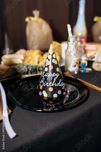 Obraz na płótnie A vibrant Birthday Party Hat rests atop a beautifully arranged Table Setting, adorned with delicious snacks, colorful treats, and festive decorations, all to enhance the joyful celebration ahead w salonie