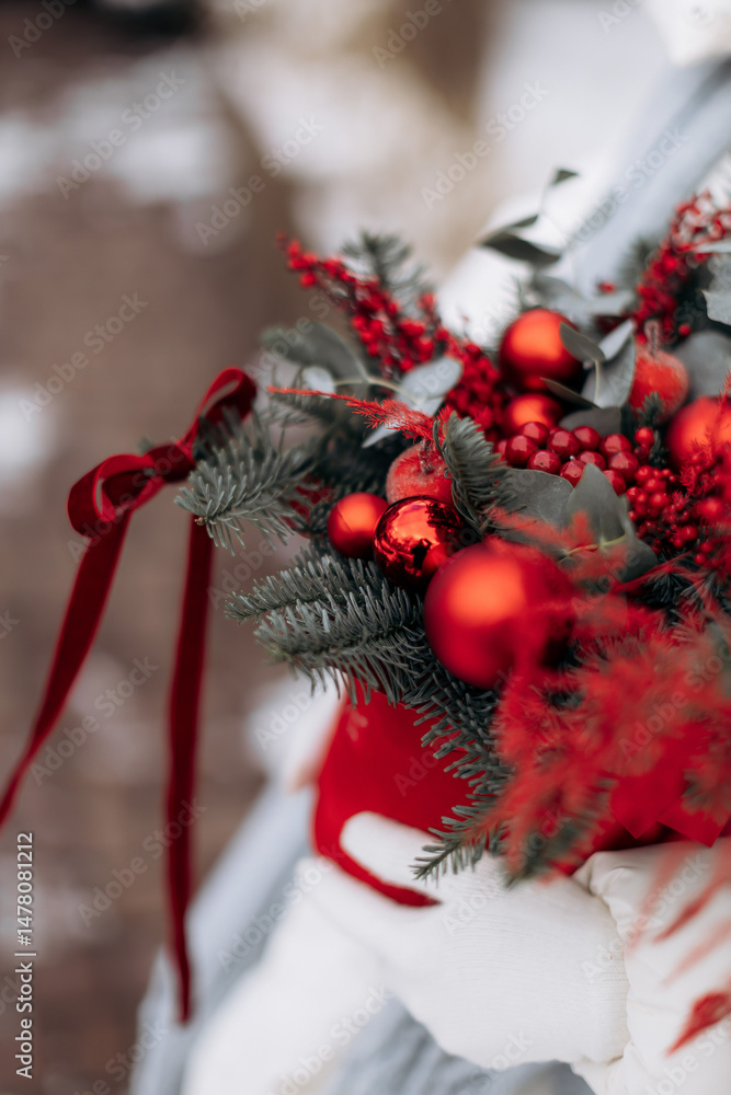This festive Christmas decoration features vibrant red ornaments and lush greenery, creating a warm atmosphere ideal for spreading holiday cheer during this joyful season of celebration