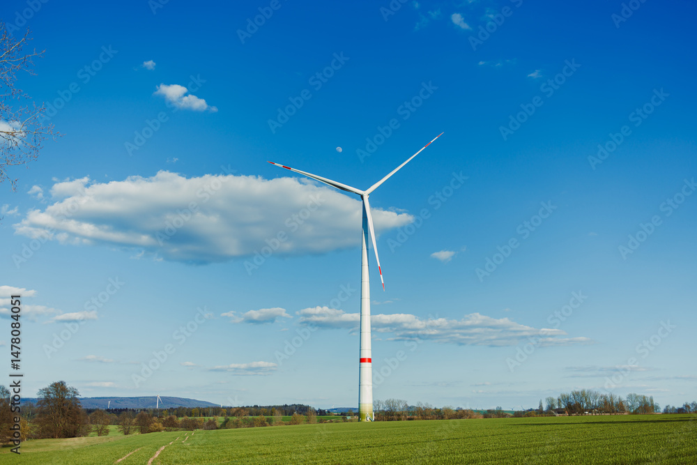 The Renewable Energy Solution A Wind Turbine Efficiently Generating Clean Electricity Amidst a Beautiful and Scenic Landscape, Perfectly Complemented by a Breezy Atmosphere and Fluffy Clouds