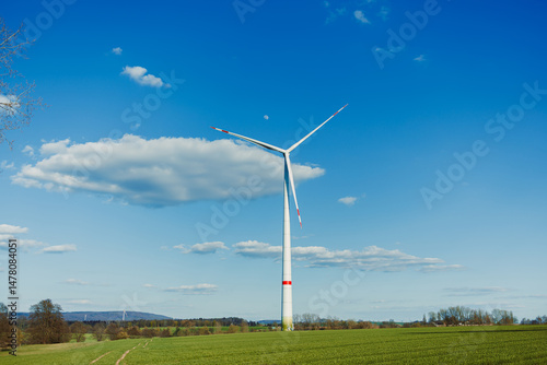 Obraz na płótnie The Renewable Energy Solution A Wind Turbine Efficiently Generating Clean Electricity Amidst a Beautiful and Scenic Landscape, Perfectly Complemented by a Breezy Atmosphere and Fluffy Clouds w salonie