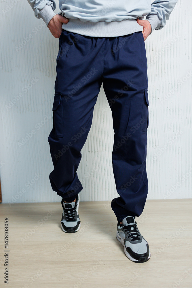 These casual and stylish mens cargo pants paired with athletic sneakers create a trendy look that is perfect for a modern setting, combining comfort and fashion seamlessly for everyday wear