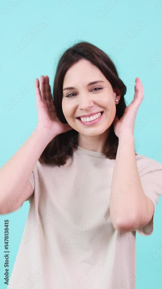 Young woman posing and smiling on turquoise background Young woman posing and smiling on turquoise background