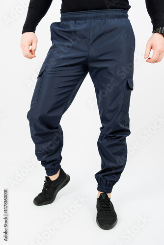 Obraz na płótnie Discover the ultimate combination of style and functionality with our Stylish Mens Navy Cargo Pants. Designed with elastic cuffs, they provide comfort and flexibility for an active lifestyle w salonie