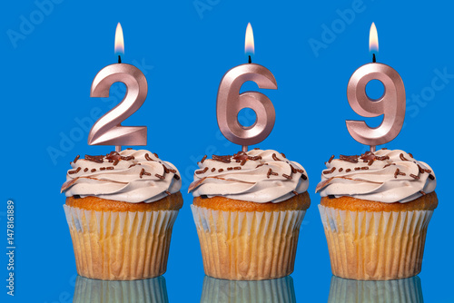 Birthday Cupcakes With Candles Lit Forming The Number 269.