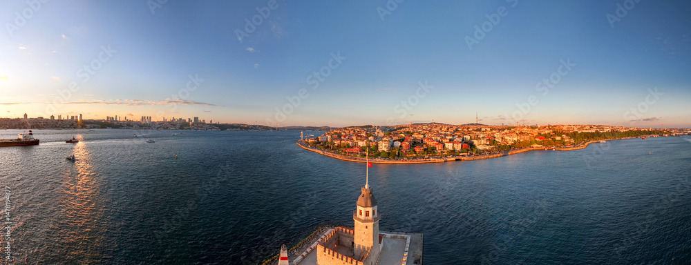 Naklejka premium Kiz Kulesi Panoramic view of Istanbul's skyline and the Maiden's Tower. An aerial panoramic shot of the Istanbul skyline, showcasing the Maiden Tower and the surrounding cityscape. Sunset sunrise tour
