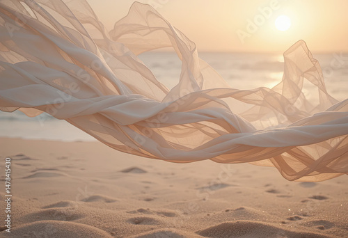 Fototapeta Naklejka Na Ścianę i Meble -  Elegant white fabric flowing above sandy beach at golden sunset with soft ocean waves in background, capturing freedom, femininity, and peaceful natural beauty