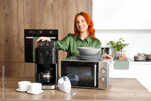 Young redhead woman with co...