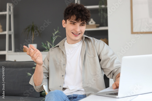 Young man video chatting wi...