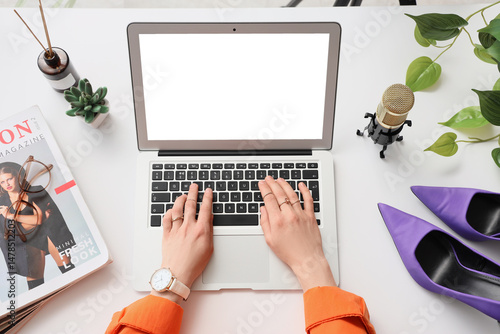Female blogger using laptop...
