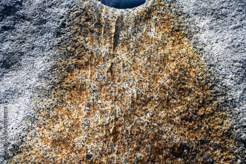 Canvas Print Water flowing down a large granite rock fountain in a garden, as a nature backgr