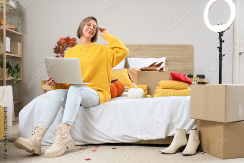 Young woman with laptop sho...