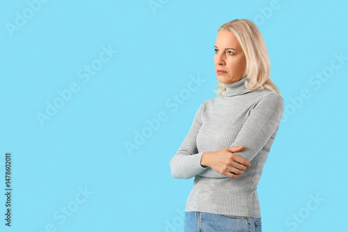 Worried mature woman on blu...
