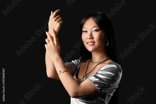 Young Asian woman in silver...