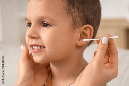 Wallpaper Mural Mother with cotton bud cleaning her little son's ears at home, closeup Torontodigital.ca