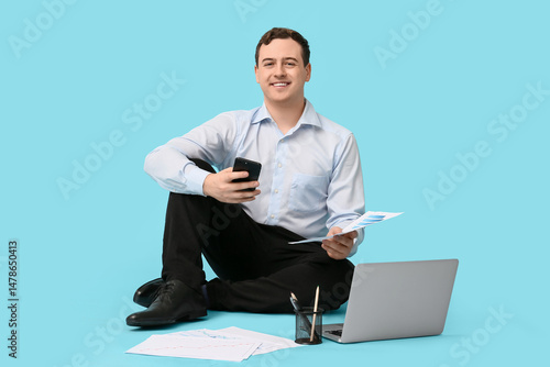 Happy young businessman wit...