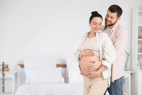 Happy pregnant couple huggi...