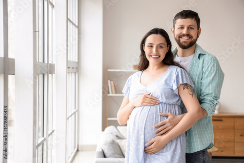 Happy pregnant couple huggi...