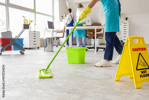 Female janitor mopping floo...
