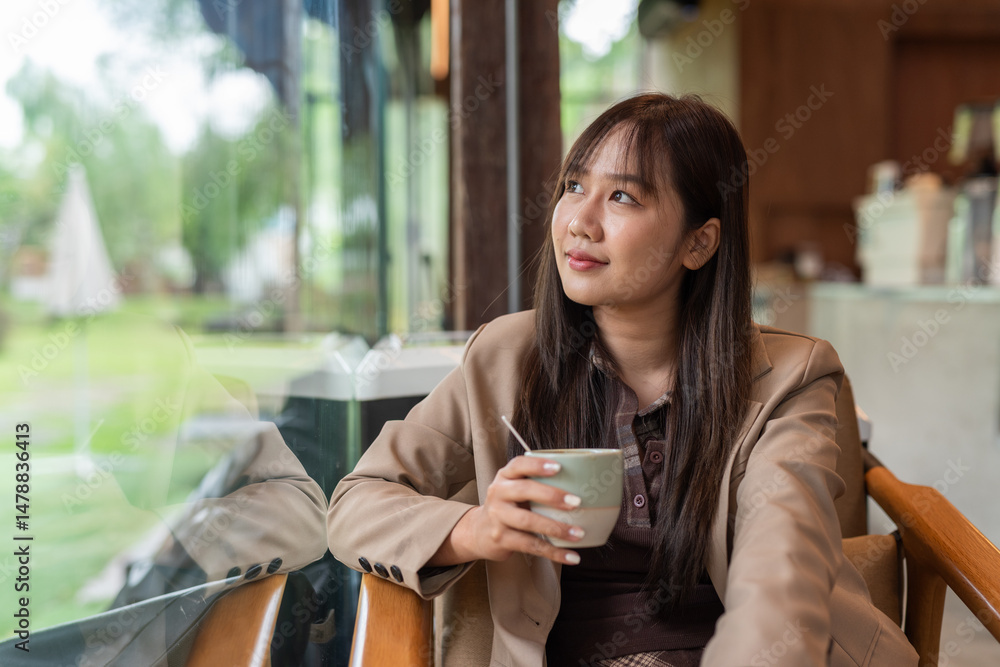 woman drinking coffee in cafe and looking through window woman drinking coffee in cafe and looking through window