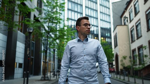 Wallpaper Mural A young professional, walking among the skyscrapers of Frankfurt’s finance hub. It captures modern business life, urban energy and the corporate atmosphere in Germany’s economic capital. Torontodigital.ca