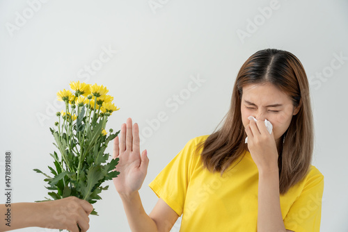 Photos Pollen Allergies, asian young woman sneezing in a handkerchief or blowing in a wipe, allergic to wild spring flowers or blossoms during spring