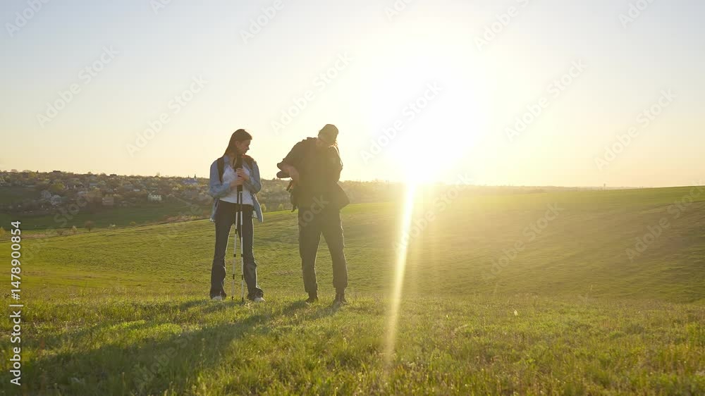 Hikers Enjoying a Scenic Landscape in the Sunshine Hikers Enjoying a Scenic Landscape in the Sunshine