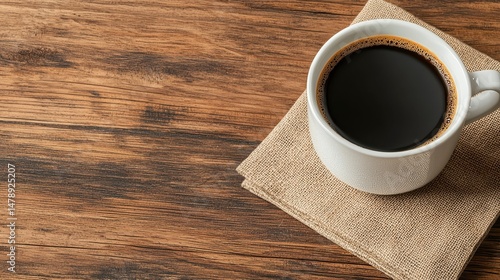 Steaming Black Coffee in White Cup on Rustic Wooden Table with Textured Cloth Underneath