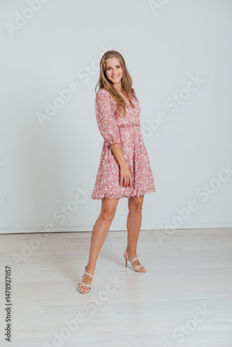 Wallpaper Mural Beautiful blonde woman in summer pink dress on white background Torontodigital.ca