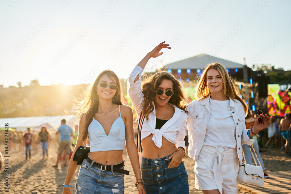 custom made wallpaper toronto digitalHappy young women dance at sunset beach party. Friends enjoy summer music festival, carefree moments by sea. Girls in trendy outfits celebrate, vibe with crowd. Sunlit sand, fun memories captured.