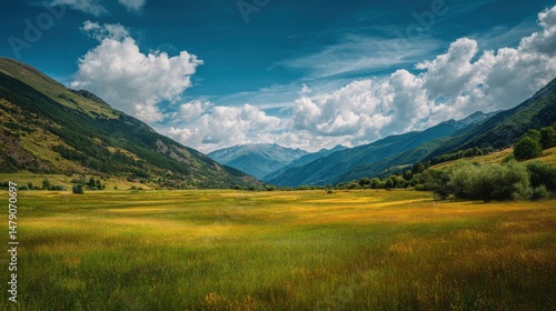 A 4K photo of empty green meadow with moutains in the background, grass field with a bit of blue sky at summer.