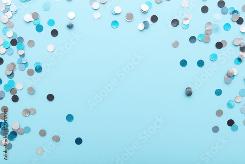 blue and silver confetti on a blue background
