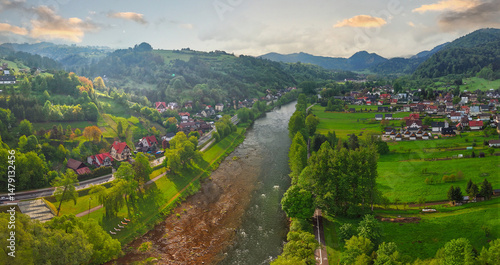 Panoramic drone view of the Dunajec River and Pieniny Mountains on a spring morning in Krościenko, Poland.
