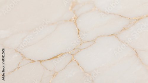 Elegant close up view of a luxurious light off white surface with gold veins