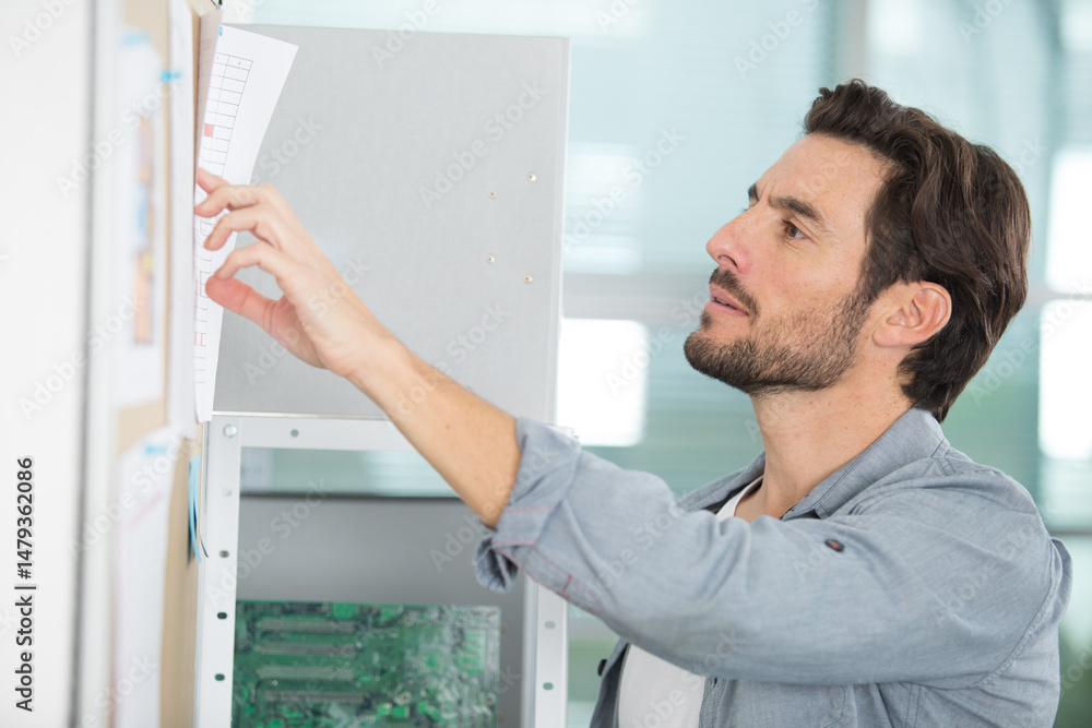 Fototapeta premium man consulting a noticeboard