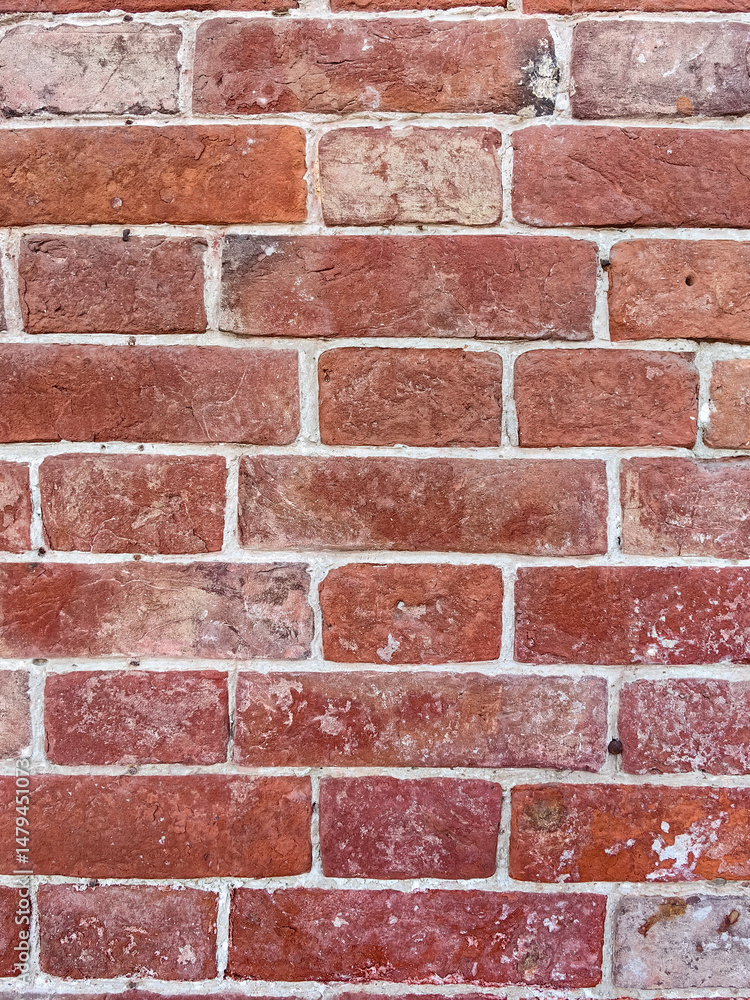 Fototapeta premium background of textured red brick wall with white cement joints