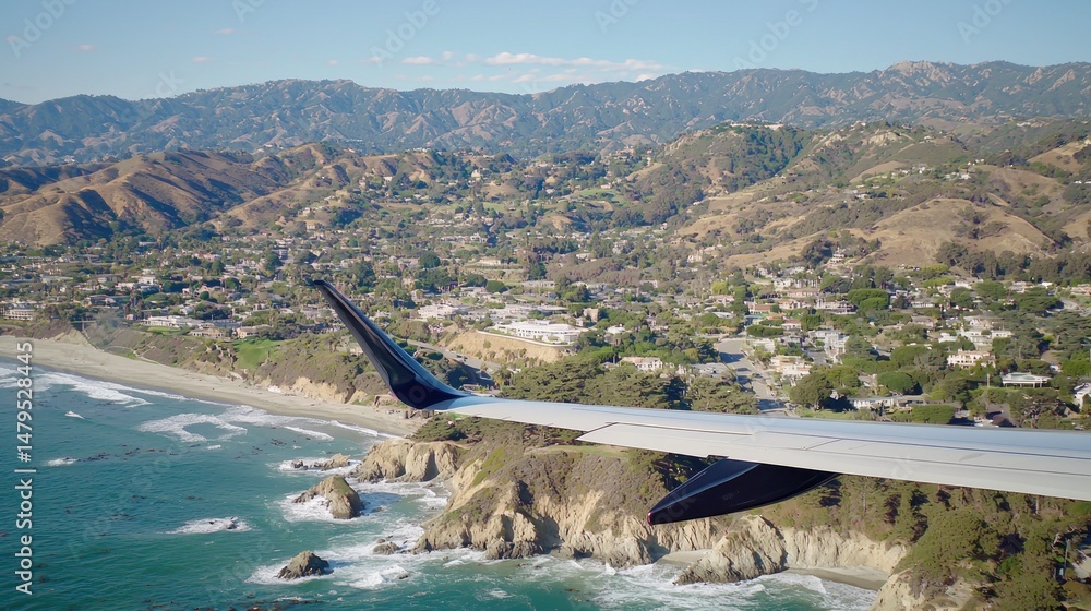 Fototapeta premium High-angle view of coastal landscape from airplane wing.