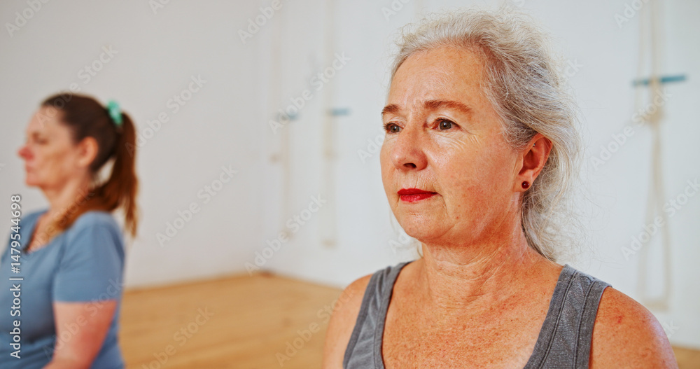 Fototapeta premium Yoga, fitness and senior woman in class, workout and hobby with retirement, warm up and health. Pensioner, mature people and elderly person in studio, exercise and balance with wellness and break