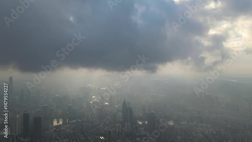 Dark clouds gather over city skyline before the approaching storm
