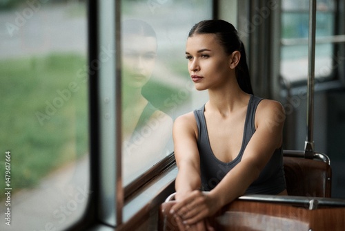 A girl rides on a streetcar next to the window Free Download A girl rides on a streetcar next to the window - GFXLoad